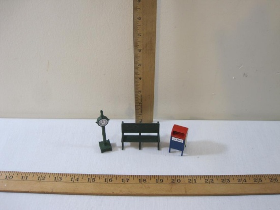 Three Department 56 Train/Christmas Display Accessories including clock, park bench, and US Mail