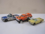 Three Miniature Diecast Cars including Cobra 5 Slot Car, Matchbox Police Car and Batman Pontiac