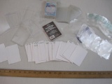 Lot of Assorted Magic The Gathering Card Accessories including sleeves, plastic boxes, and dividers,