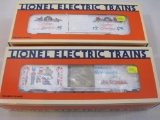 Two Lionel Christmas Boxcars including 1991 O Gauge Christmas Boxcar 6-19913 and 1992 O Gauge
