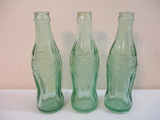 Three Vintage Glass Coca-Cola Bottles, two 6 fl oz and one 6 1/2 fl oz, marked New York, 2 lbs 11 oz