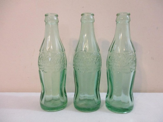 Three Vintage Glass Coca-Cola Bottles, two 6 fl oz and one 6 1/2 fl oz, marked New York, 2 lbs 11 oz
