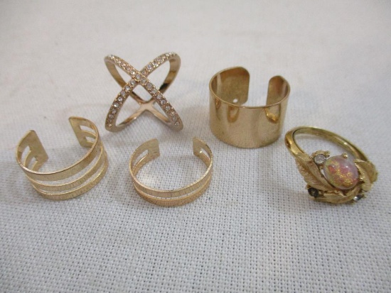 Five Gold Tone Rings including rhinestone x ring and more, 1 oz