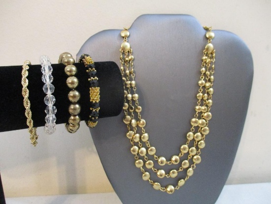 Four Costume Bracelets and Gold tone Multi-strand Necklace, 3 oz