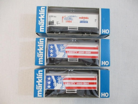 Three Marklin HO Scale Train Cars including two Liberty 1886-1986 Boxcars and The Spirit of MEA