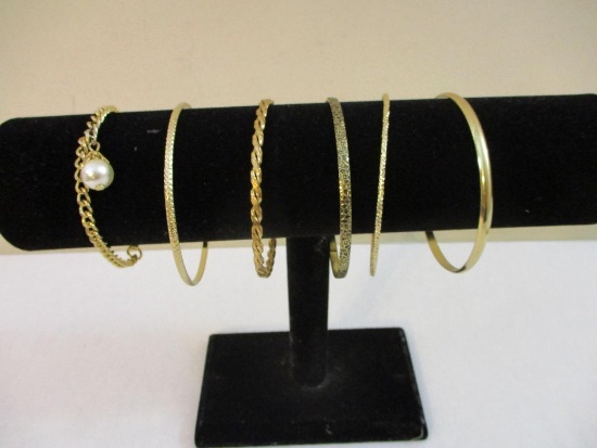 Six Gold Tone Bracelets including bangle and faux pearl, 2 oz
