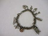 Silver Tone Charm Bracelet with assorted charms: train, car, airplane, lock & key, skateboard,