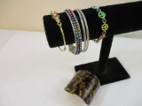 Six Assorted Bracelets including acrylic cuff animal print, peace signs, and more, 3 oz