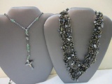 Two Necklaces including metallic beaded necklace with crucifix and multistrand black beaded