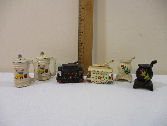 Three Sets of Vintage Cast Iron Salt and Pepper Shakers including trolley cars, cookstoves, and