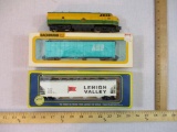 Three HO Scale Train Cars including AHM Reading Lines Diesel Locomotive 266, AHM Lehigh Valley