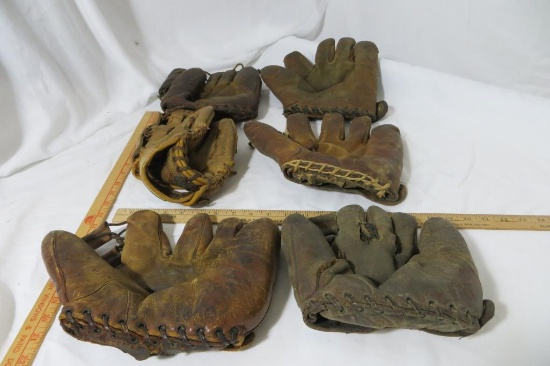 Six Very Old Baseball Gloves, 5 catcher, 1 regular.