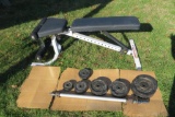 Body Solid weight bench with bar and 12 weights. 2 - 13.2 lbs (6 kilos), 4 - 8.8 lbs (4 kilos), 4 -