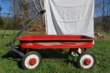 Red Wagon. One hubcap needs to be reattached. Rusty but works good.