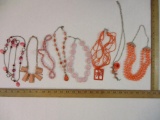 Eight Pink/Coral Necklaces including palm tree pendant and pink glass beads, 11 oz