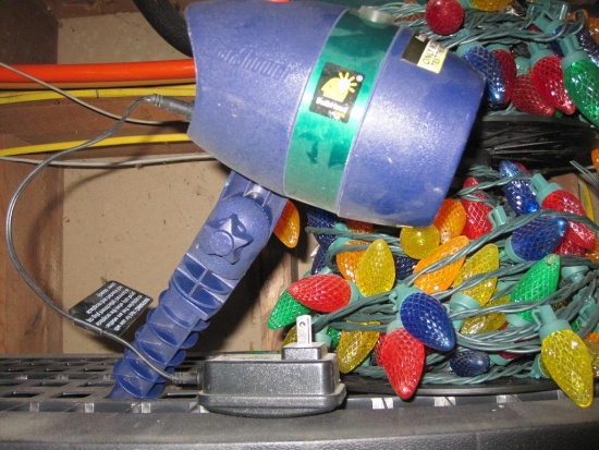 Two Plastic Spools of Christmas Lights and a Star Lazer Projector