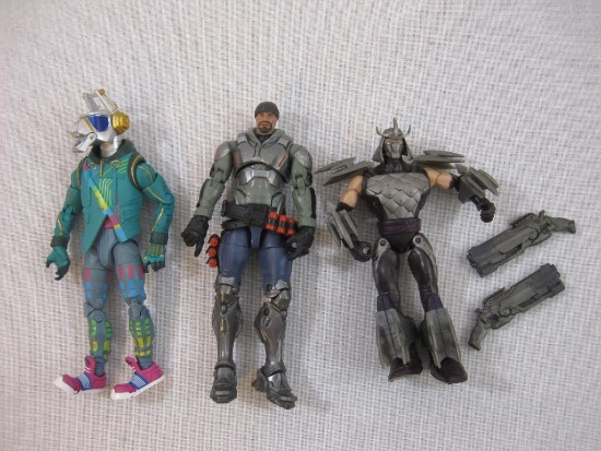 Three Assorted Action Figures from Fortnite, Teenage Mutant Ninja Turtles Shredder, and Overwatch