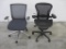 Two Ergonomically Designed Office Chairs with Castor Wheels and Adjustable Height, By Herman Miller