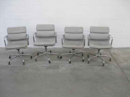 Four Swiveling Grey Office Chairs with Castor Wheels and Adjustable Height