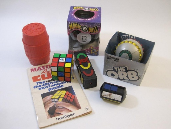 Assorted Vintage Games and Puzzles including Rubiks Cube, Barrel of Monkeys, The Orb, Magic 8 Ball