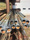 SHELF OF NUMEROUS STICKS OF GALVANIZED PIPE