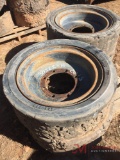 (1) SOLID SKID STEER TIRE MOUNTED 7 LUG STEEL WHEEL