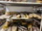 SHELF OF VARIOUS BUCKET TEETH AND SHANKS