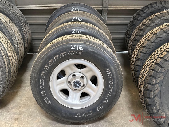 (4) USED BRIDGESTONE DUELER 235/75R15 W/ 5 LUG JEEP WHEELS