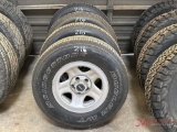 (4) USED BRIDGESTONE DUELER 235/75R15 W/ 5 LUG JEEP WHEELS