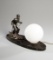 A continental Art Deco period table lamp featuring a skier, the silvered fi