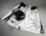 Mike Tyson signed boxing glove and trunks, a black right-hand Reyes glove s