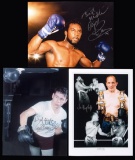 Three large colour photographs signed by the British boxers Henry Cooper, N
