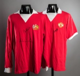 Two Manchester United retro home jerseys bearing signatures of the 'Holy Tr