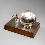 A gentleman's desk ornament, in the form of a chrome football and footballe
