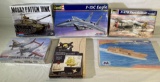 Model kits: (2) Revell planes, (2) Monogram tank & wood aircraft carrier, pirate ship