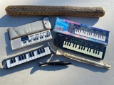 Casio and Hohner handheld keyboard instruments, recorders & rain stick