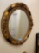 Ornate gilded oval mirror 32