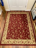 Rug 6' x 4 1/2 ' red and beige floral pattern