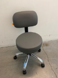 Gray rolling physician's exam chair