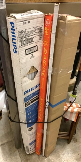 2 New Packages of Carpet Trim 2' x 72", New In box (4) t-8 Bulbs and Assortment of weather Stripping