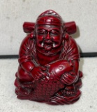 Laughing Buddhist Monk Holding fish symbolizes Good Fortune