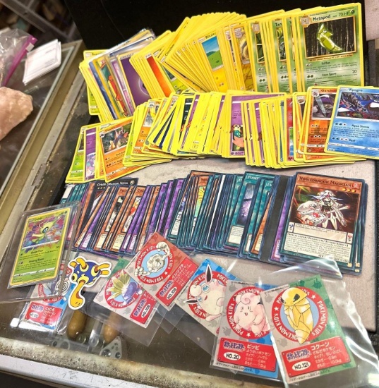 Group of Unsearched Pokemon Cards and Yu-Gi-Oh Cards