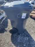 Grey plastic trash barrel