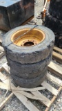 (4) solid skidsteer tires and rims