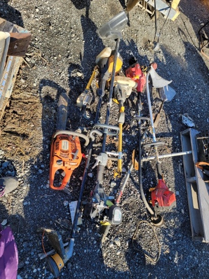 Lot of chainsaws and weed Wackers