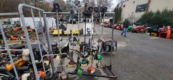 Rolling cart of assorted weed wackers