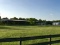 Tract 2: 10.4 acres with 80' x 200' lighted covered arena, 6 stall barn & workshop with lush pasture