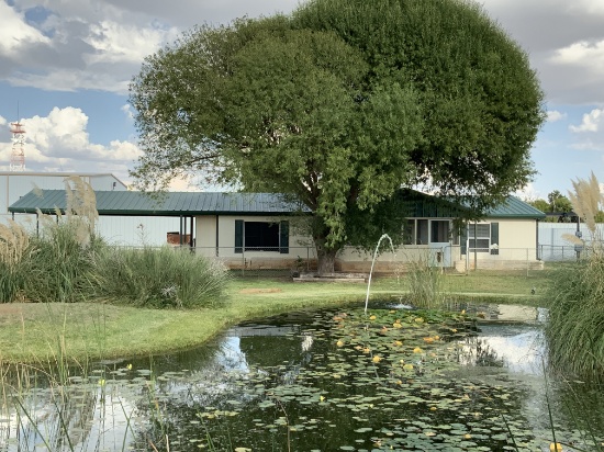 Parcel #2: Modular Home with attached carport and lily pond. Fenced on one half acre