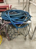 Shopping Cart Full Of Assorted Water Hose And A Hose Reel Wagon