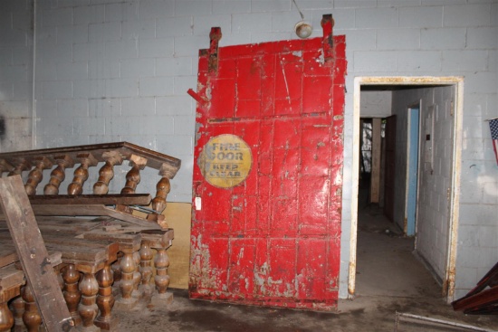 Vintage industrial red fire door with FIRE logo; dimensions approx. 2.5" x 57"x 100" tall